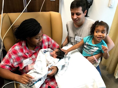 Akosua Taylor, her husband, her toddler and her newborn after a fetal spina bifida surgery