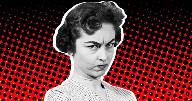 A woman with a 50's hairstyle with a red-black abstract background looking angry 