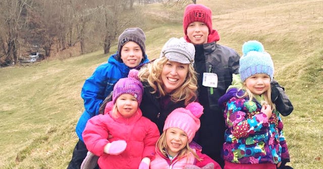 Tara Schoeller smiling and posing with her three daughters and two sons outside