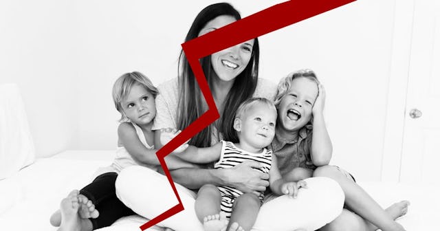 A mother posing with her three little kids in a bedroom