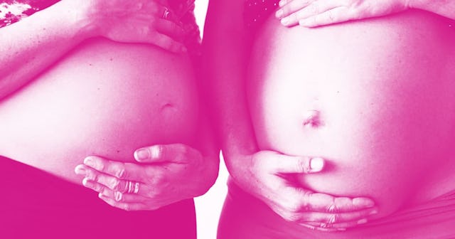 Two women standing next to each other with their hands on their baby bumps with a pink color filter