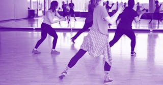 Four girls at dance class dancing around.