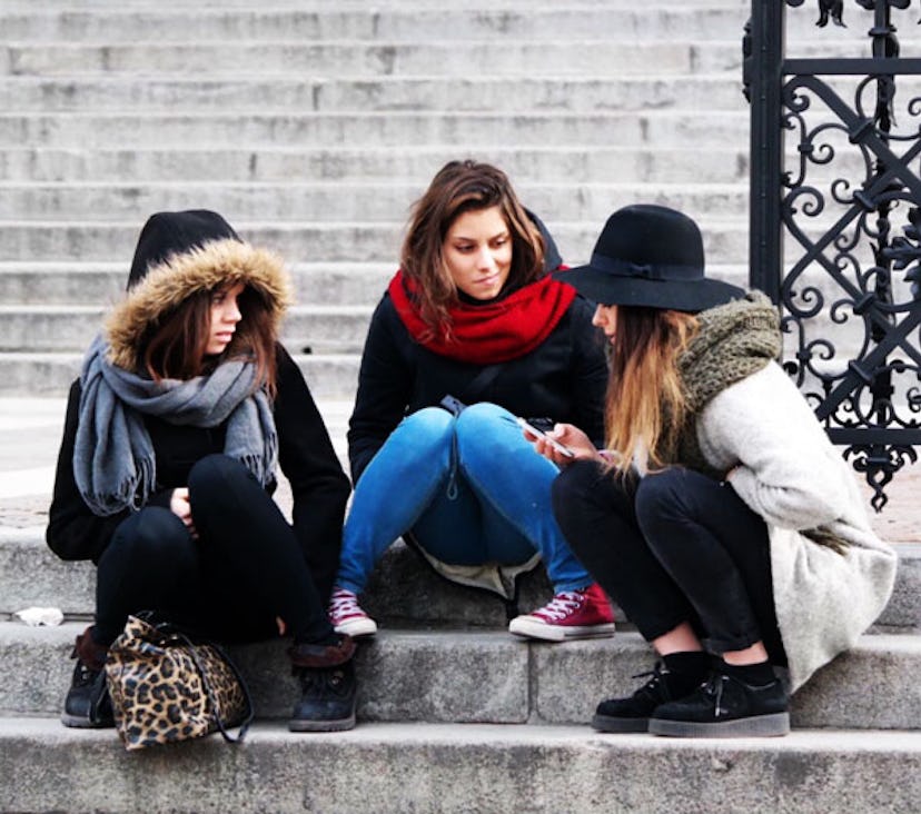A group of women sitting on the stairs and talking about experiencing tragedy or adversity