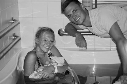 Parents with their newborn baby after water birth 
