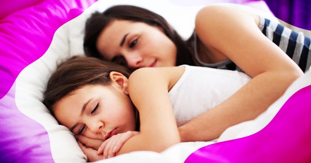 Mother sleeping with her child in bed