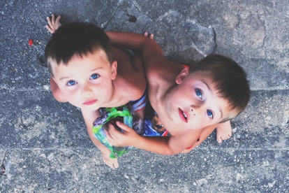Blue-eyed twins looking up 