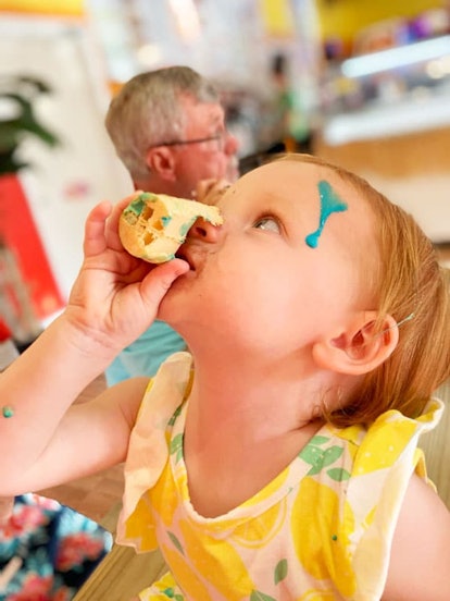 A child getting messy while eating ice-cream.