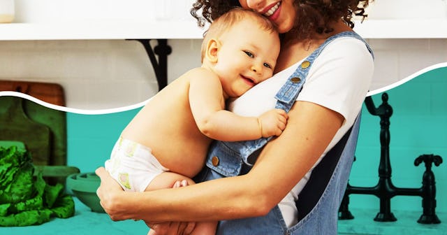 A stay-at-home mom in blue denim rompers holding her baby