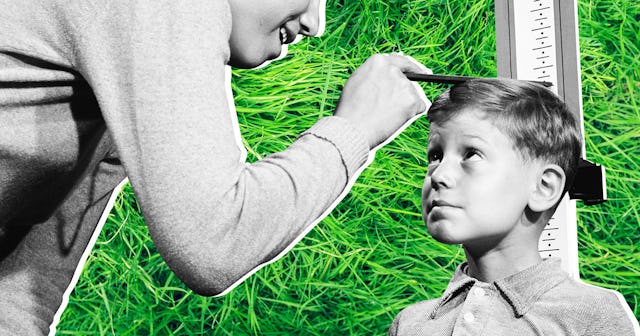 A mother measuring the height of her son