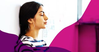 A woman in her 30s who's been called a 'Ma'am' leaning her back on a wall with her eyes closed