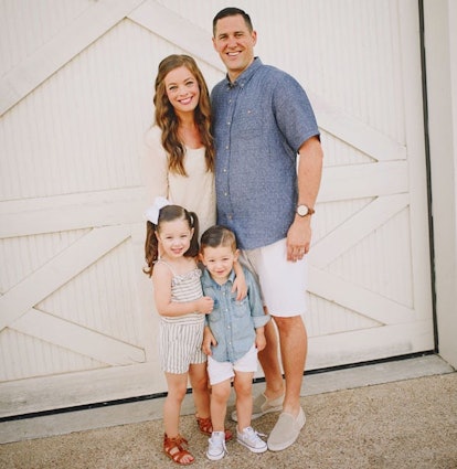 Parents posing outdoors with their kids while smiling