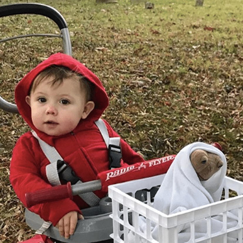 A baby wearing E.T. - inspired Halloween costume