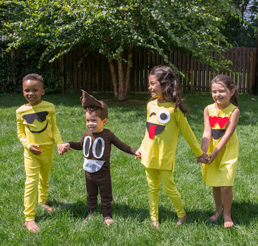 Two boys and two girls wearing black and yellow emojis kids' costumes    