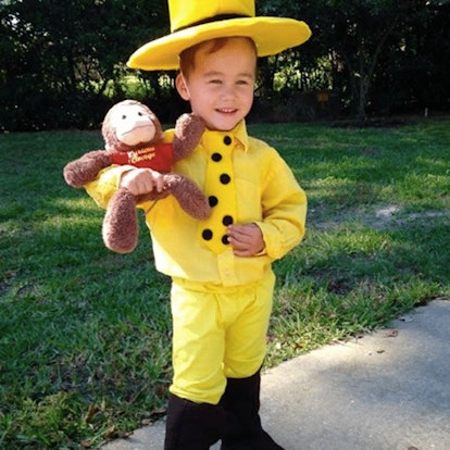 A boy wearing a Man in the Yellow Hat Halloween costume 