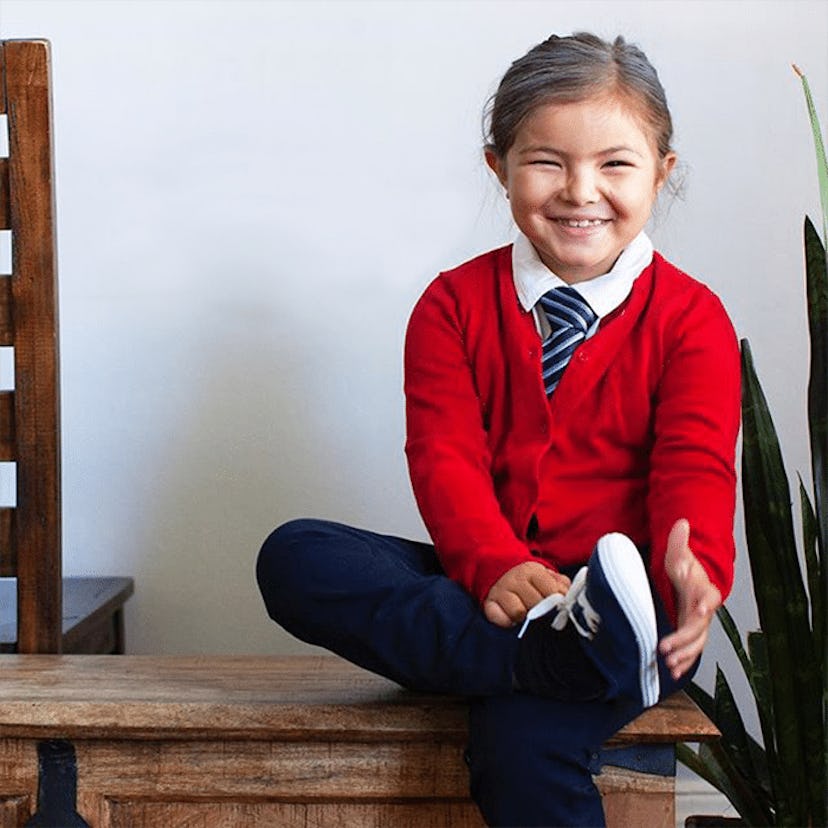 A red suit MR Rogers Halloween costume worn by a girl