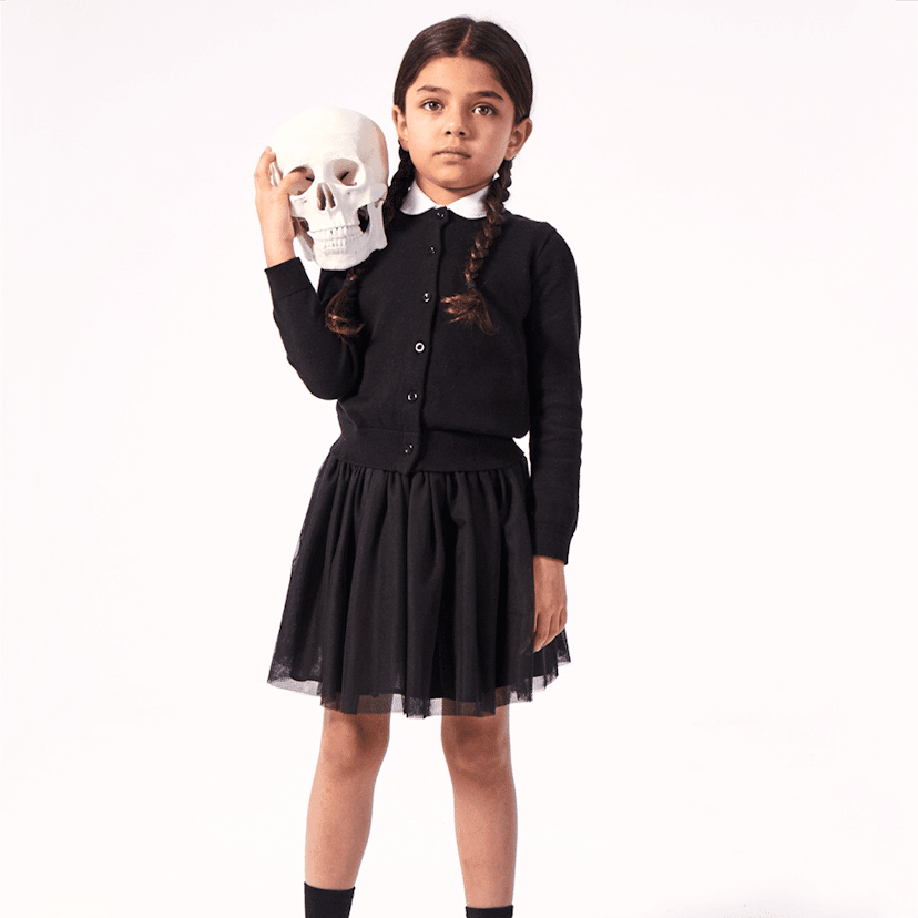 A girl wearing a black Wednesday Addams Halloween costume 