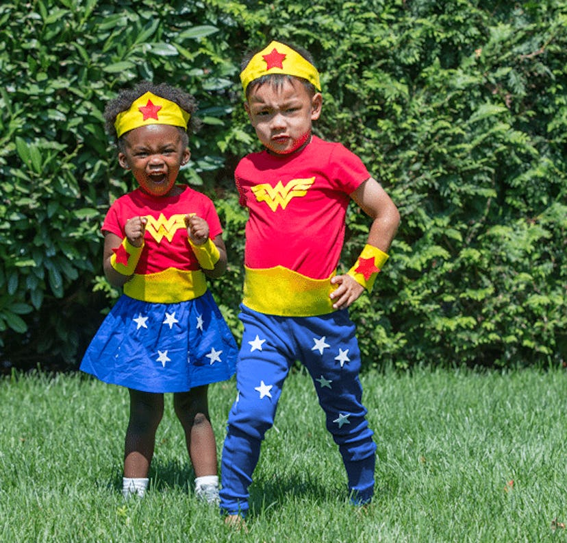 A Wonder Woman costume worn by a boy and a girl