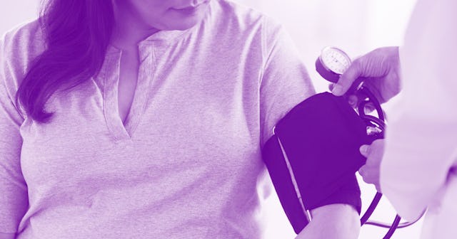 A doctor measuring a woman's blood pressure