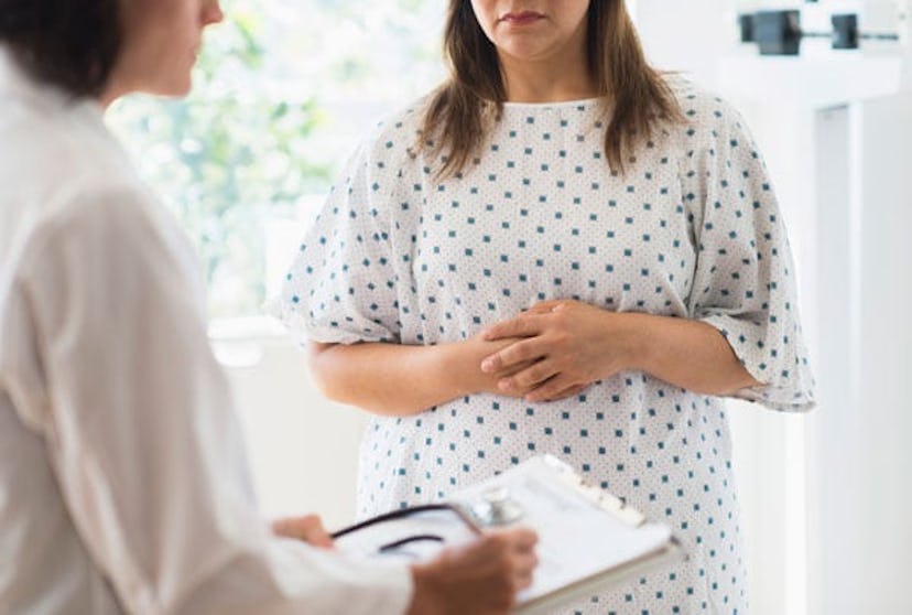 A worried woman talking with her doctor