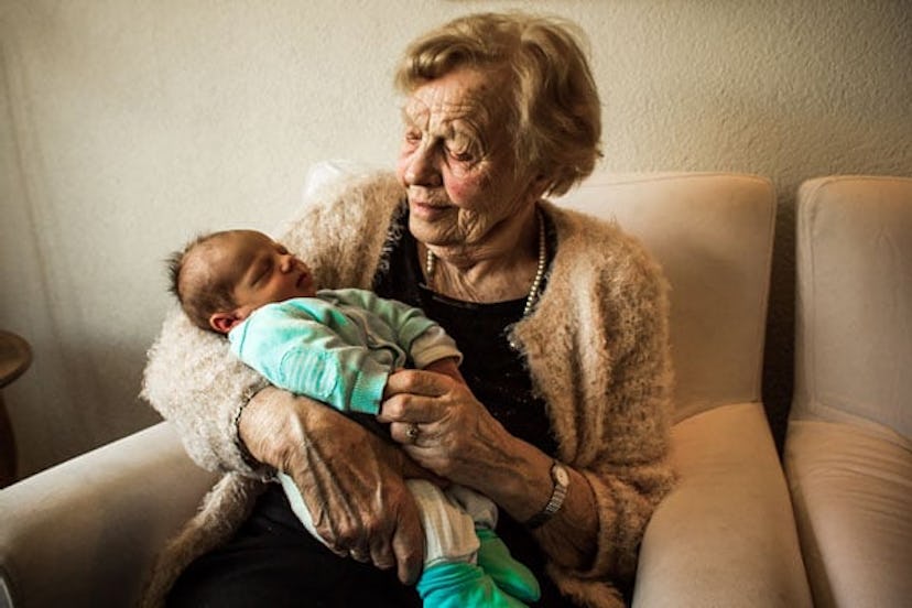 Grandma holding her newborn grandchild 