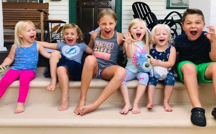 Six grandchildren sitting on a porch 