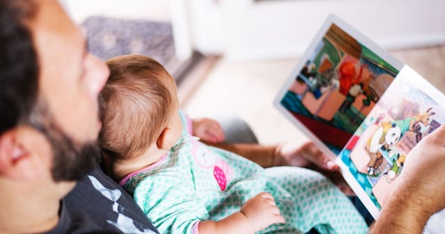 A new dad reading a picture book to his baby