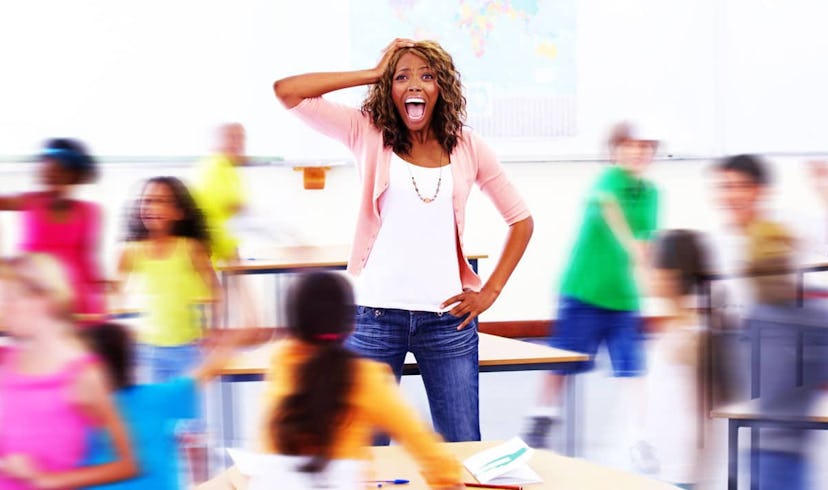 An elementary school teacher standing and screaming surrounded by blurred children in movement