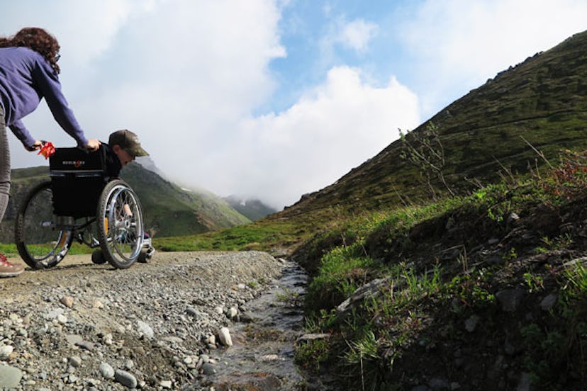 Allyson Buck pushing her son in his wheelchair during a hike 