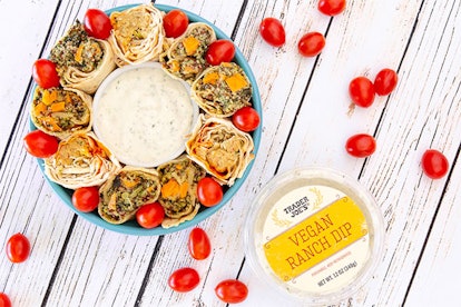 New at Trader Joe's; dip bowl surrounded by burritos and cherry tomatoes