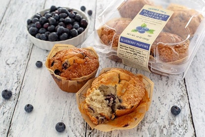 New at Trader Joe's; two blueberry muffins, a bowl of blueberries and the muffin packaging