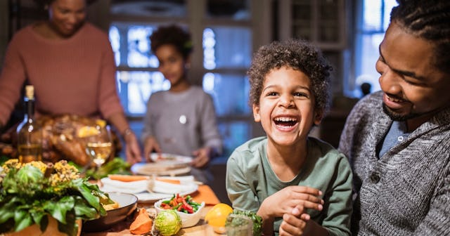 Boy laughing with father on Thanksgiving — Thanksgiving jokes.