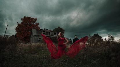 Michael Myers themed, a woman in a red dress in front of a house creating a storm
