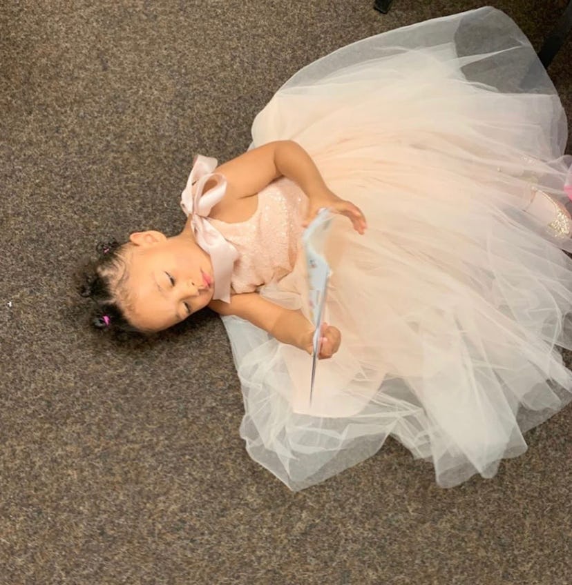 Alexis Olympia Ohanian Jr. lying down on the floor in a pink tulle dress during her flower girl duty