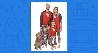 A family of four wearing Christmas pajamas with their dog