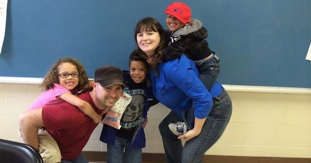Joanna Yates with her husband and their three kids, with one of them in the middle and the other two...