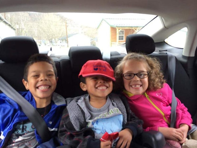 Joanna Yates's children sitting together in a car and smiling.