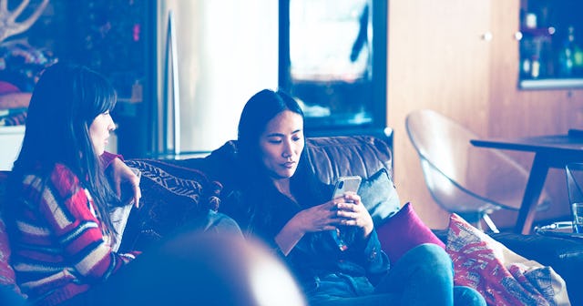 A girl talking to her friend while her friend looks on her phone representing Anchor Friends