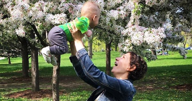 Short-haired woman playing with her kid