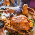 People toasting around Thanksgiving table — Thanksgiving quotes.