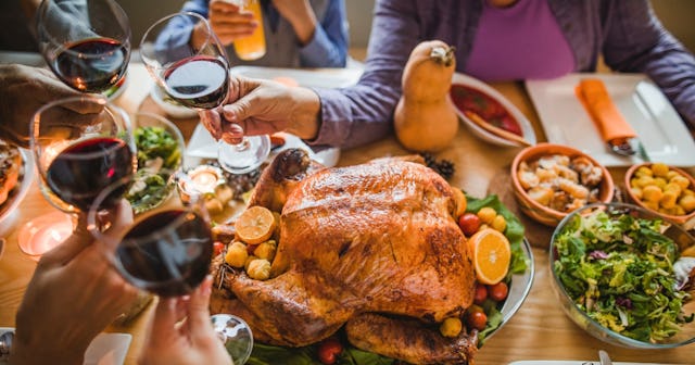 People toasting around Thanksgiving table — Thanksgiving quotes.