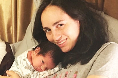 A mother with postpartum depression holding her newborn baby