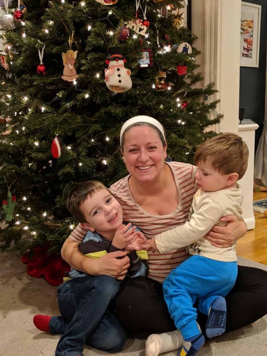 Liz Curtis Faria posing in front of a Christmas tree with her two sons