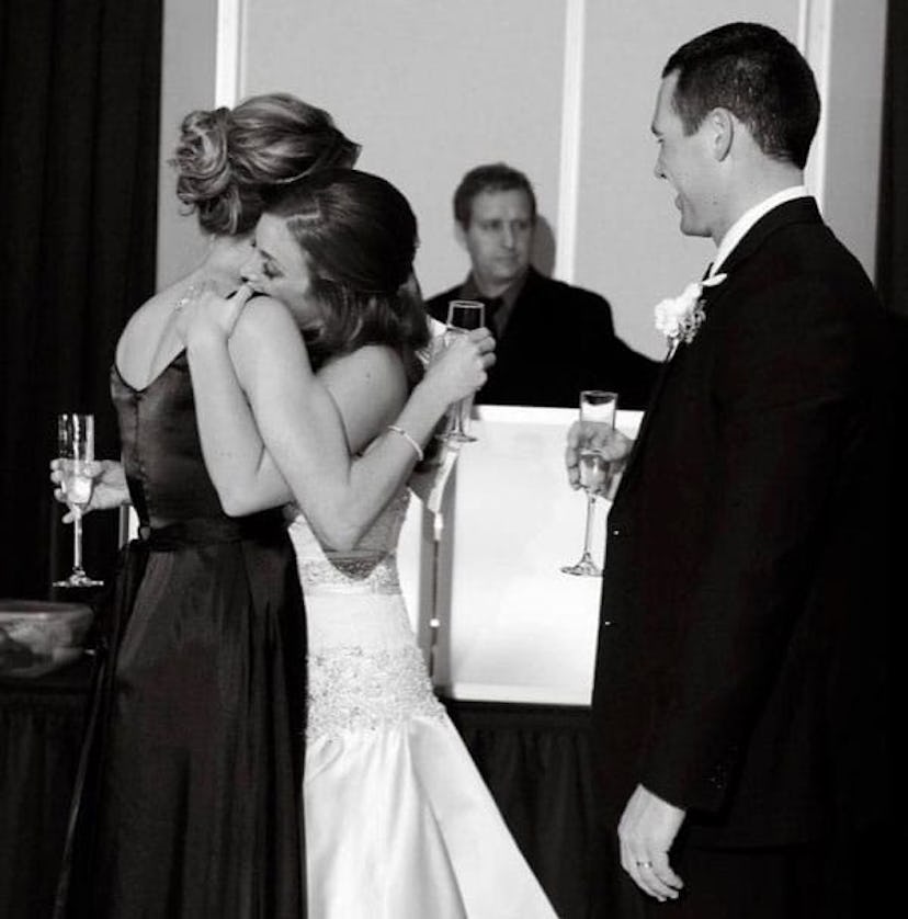 Two girls hugging at a wedding where one of them is getting married 