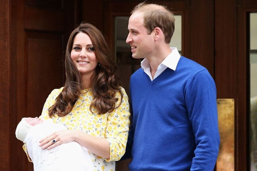 Kate Middleton and Prince William posing while holding one of their newborn babies