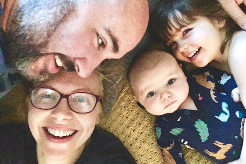 A selfie of a man and woman and two of their children.