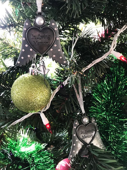 Two heart-shaped Christmas ornament with wings that has "in loving memory" engraved on it 