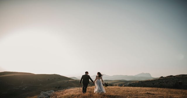 Married couple running off into the mountains