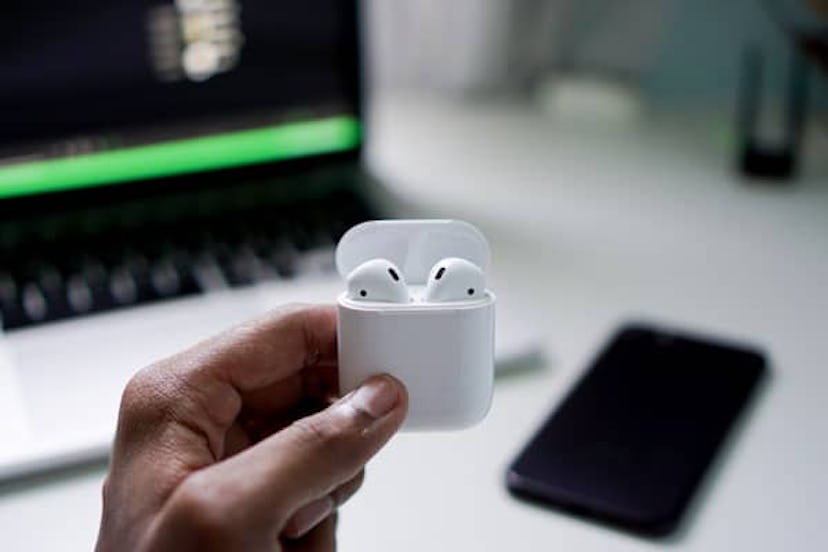 A man holding his AirPods
