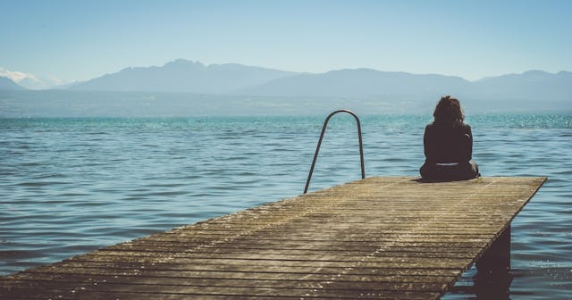 Woman sitting on dock