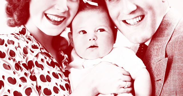 Parents taking a picture with their young child while smiling